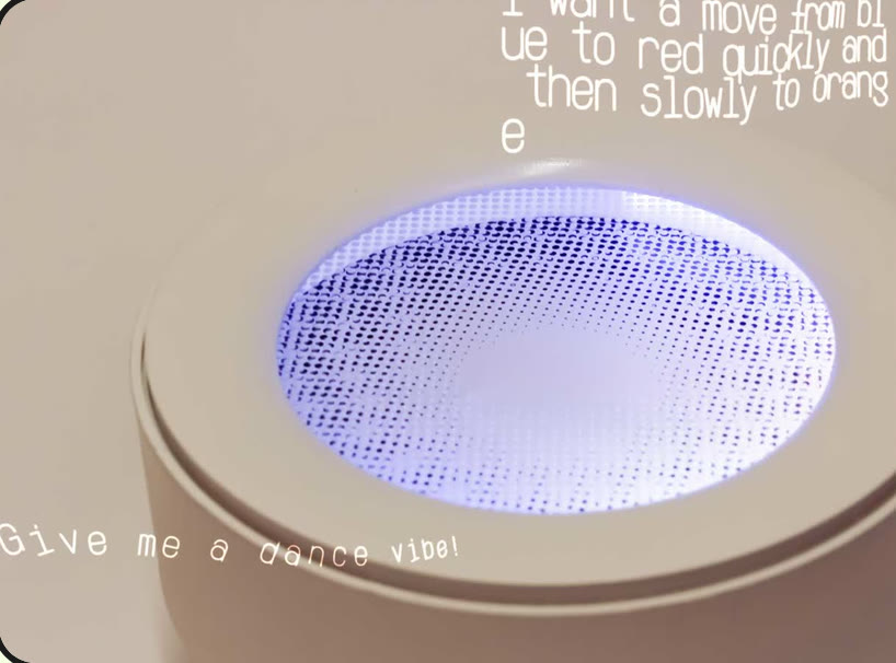 A round lamp-like artifact with its top disc glowing; handwritten prompts around it read 'Give me a dance vibe!' and 'I want a move from blue to red quickly and then slowly to orange'